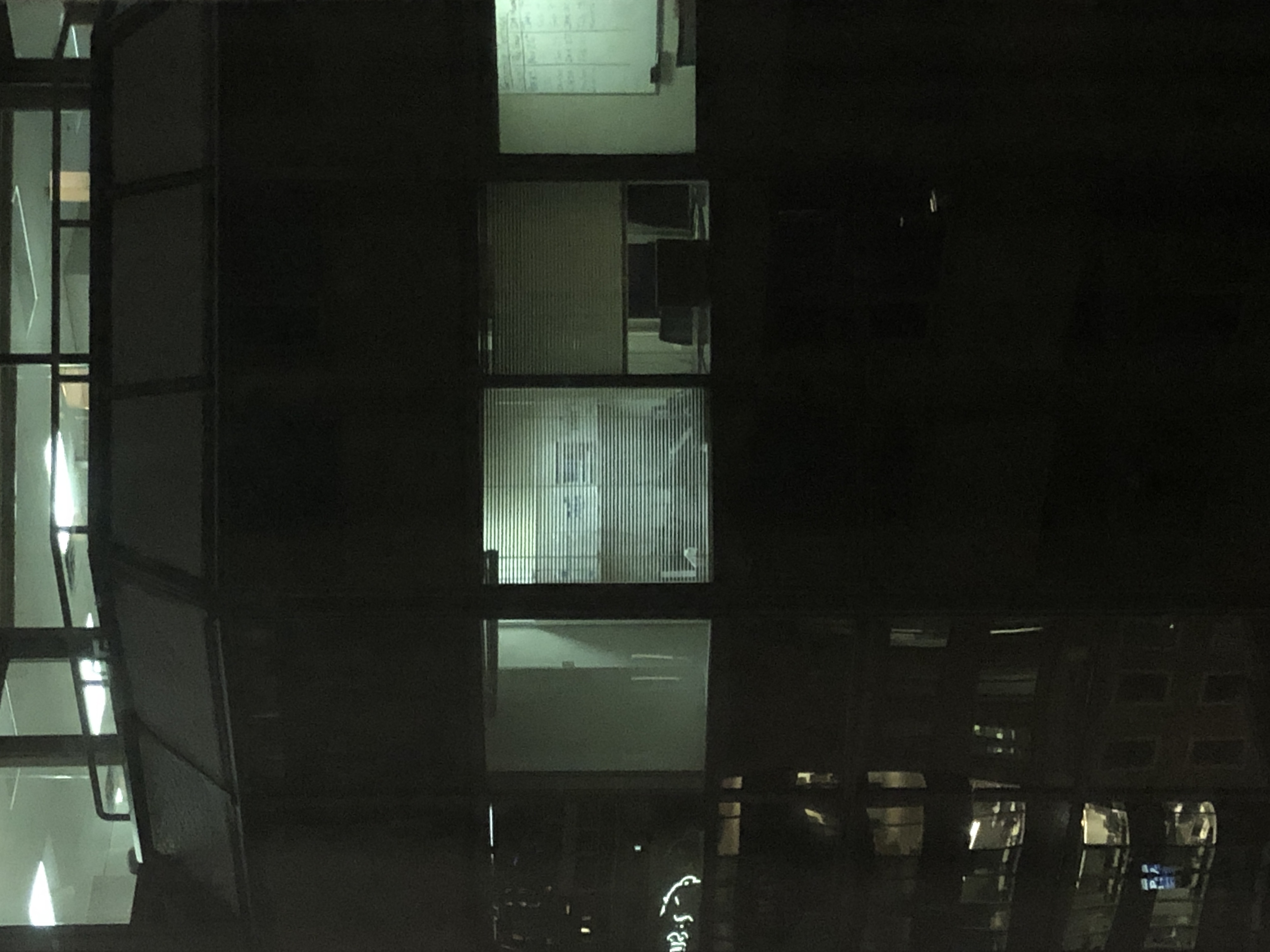 A building with windows and a balcony at night